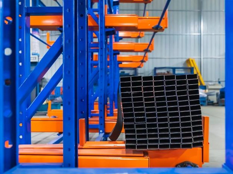 Safety stop block on telescopic cantilever rack arm end